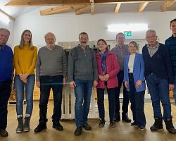 The newly elected board of the Gusen Memorial Committee (GMC). From left to right: Prof. Rudolf Haunschmied, Lena Patrejko, Peter Vogtenhuber, Reinhard Kaspar, Martha Gammer, (Rudolf Lehner), Julia Mayr, Hannes Gammer, Bernhard Mühleder.